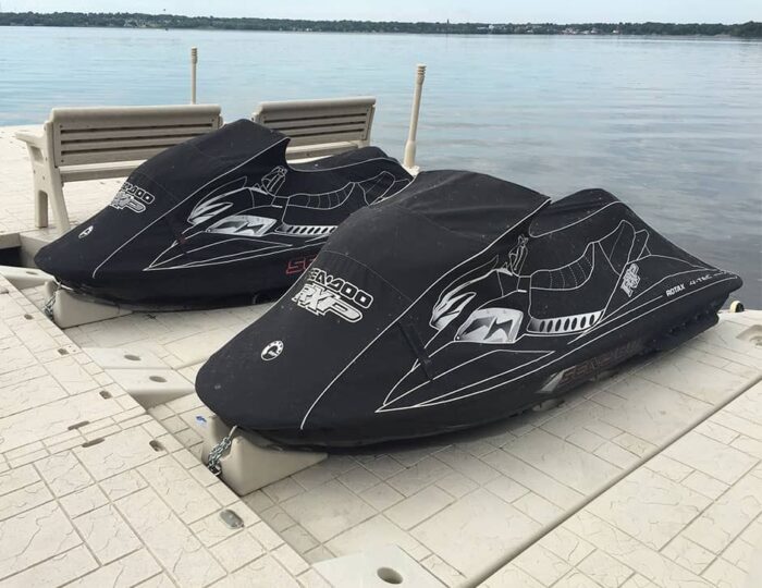 Two jet skis are secured to a SLX6 Personal Watercraft port