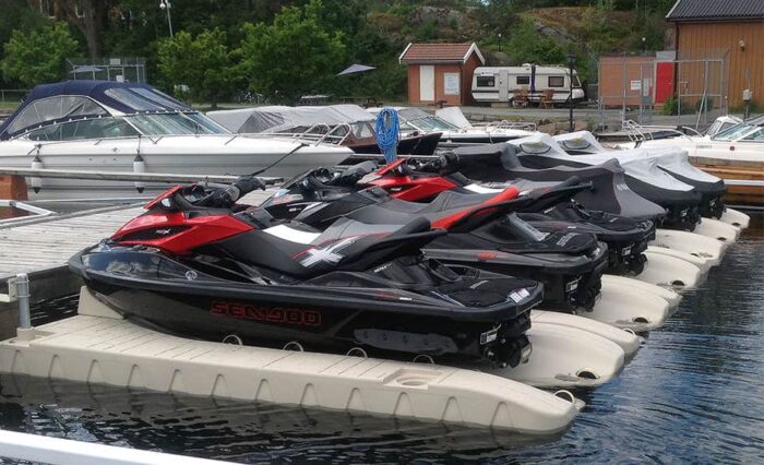 Multiple Floating Docks SLX6 Personal Watercraft ports line in at the marina.