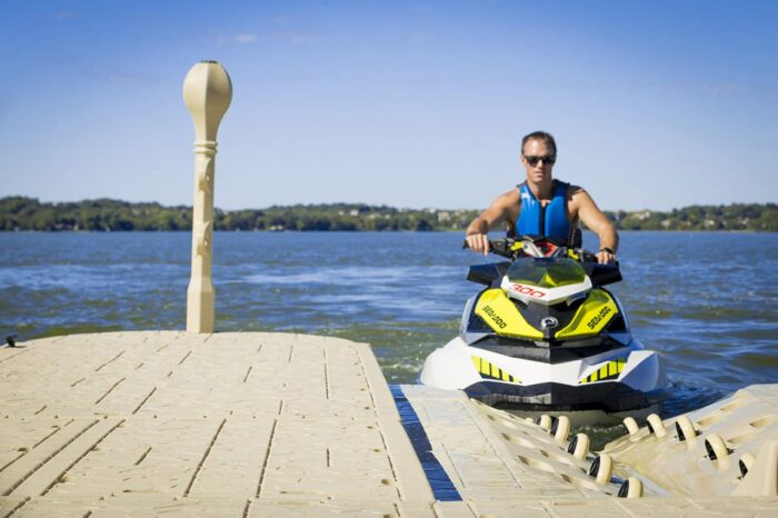 A man parks his jet ski on a Wave Armor PWC Ports.