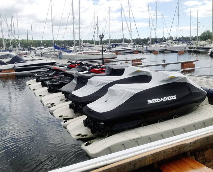 A line of Jet skis parked securely moored in the marina on Wave Armour EV05 Wave ports.