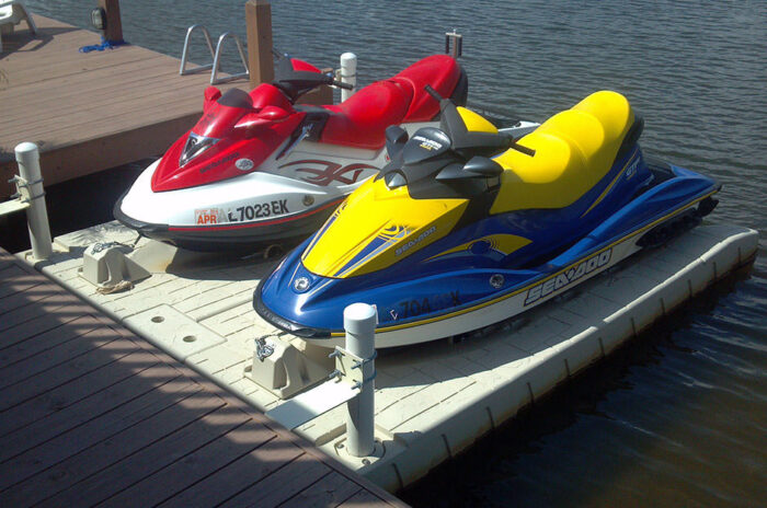 Two jet skis sit securely on top of Floating Docks supply Wave Armor PWC Ports